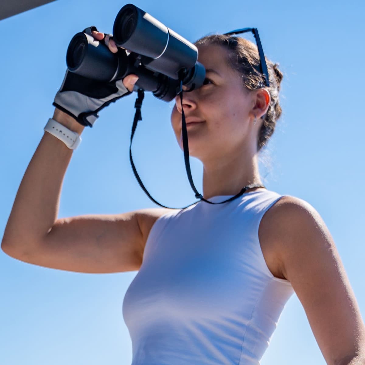 Celeste Anchor on deck, looking out through binoculars